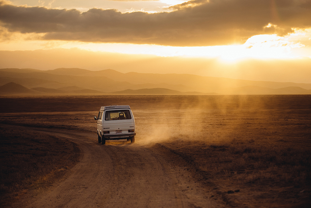 Purpose: It's like gas in a car (except way less expensive). | Image shows a old van driving through the desert as the sun sets in the background.